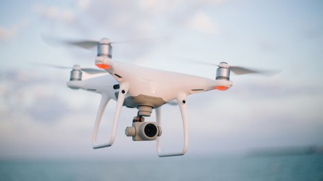 A quadcopter drone with a camera in flight