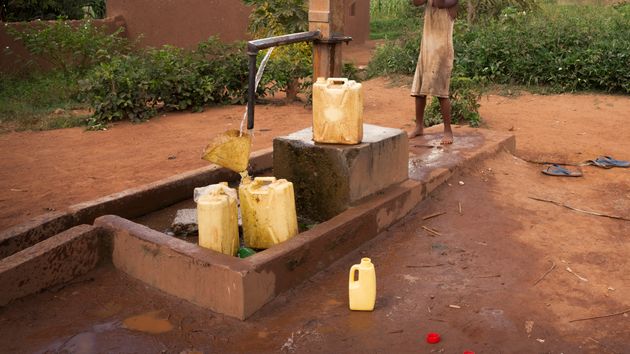Cans being filled by a water pump
