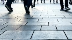 A view from street level of pedestrians walking